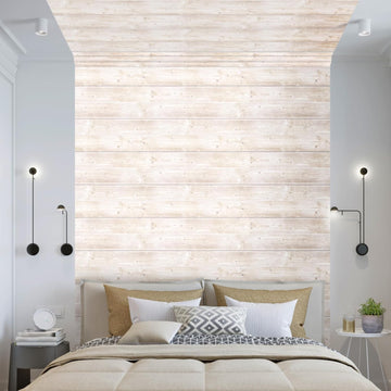 Peel and stick accent wall panels in a whitewashed wood-plank print running full height on the wall behind an upholstered bed, stopping short of both corners