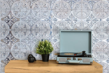Silver Fleur metal tiles for walls used as a decorative statement wall behind a living-room console and record player
