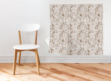 A Meet Cute peel and stick wallpaper sheet applied as a framed wall panel beside a wooden chair