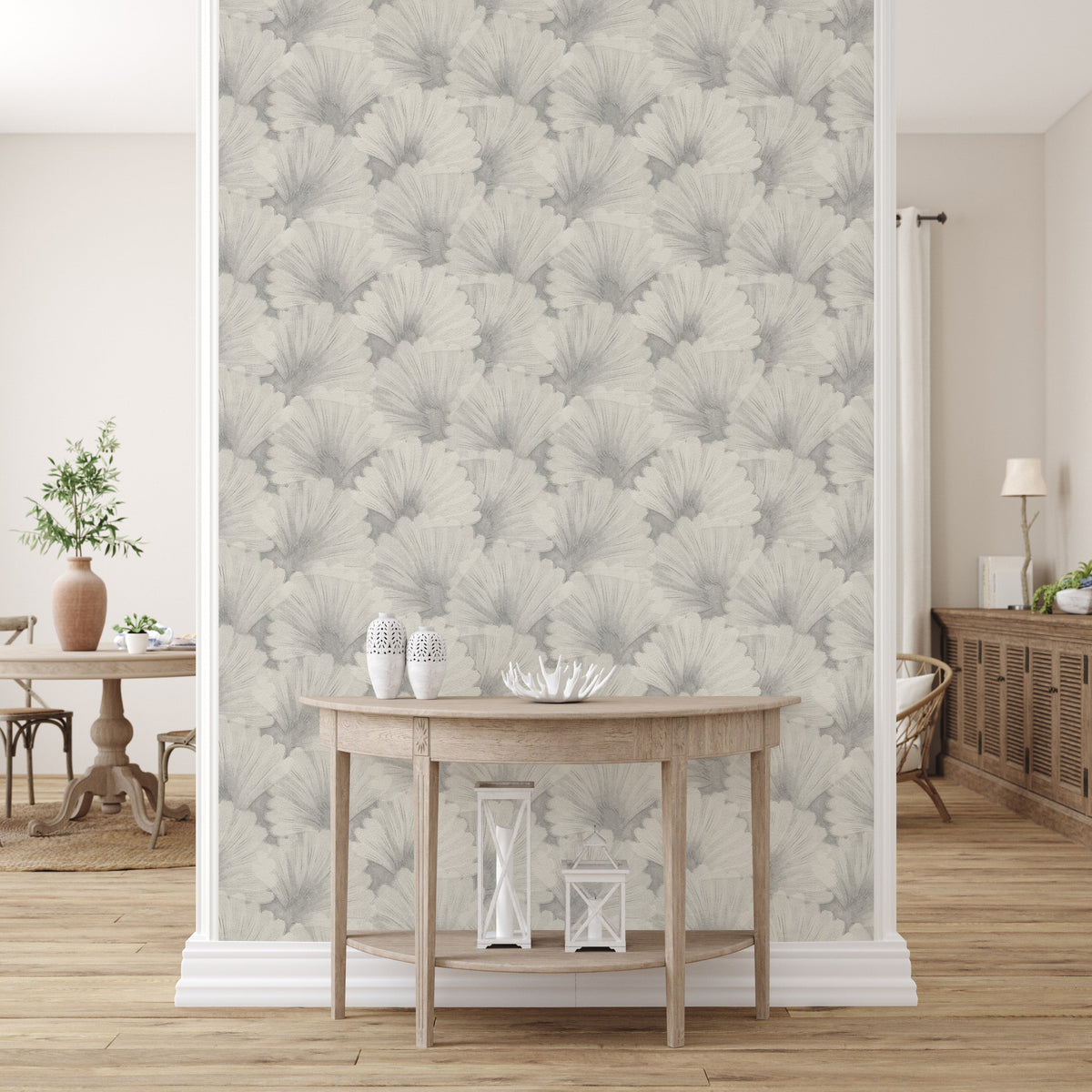 Grey fan-patterned peel-and-stick wallpaper covering a narrow feature wall between white pilasters, behind a demilune console table with white vases and lanterns