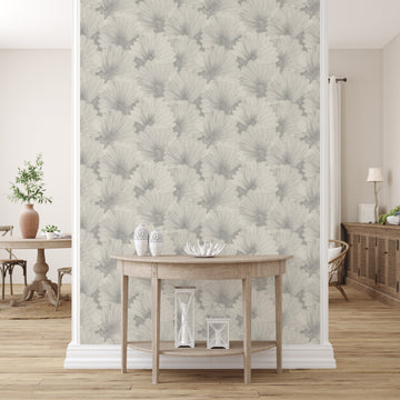 Grey fan-patterned peel-and-stick wallpaper covering a narrow feature wall between white pilasters, behind a demilune console table with white vases and lanterns
